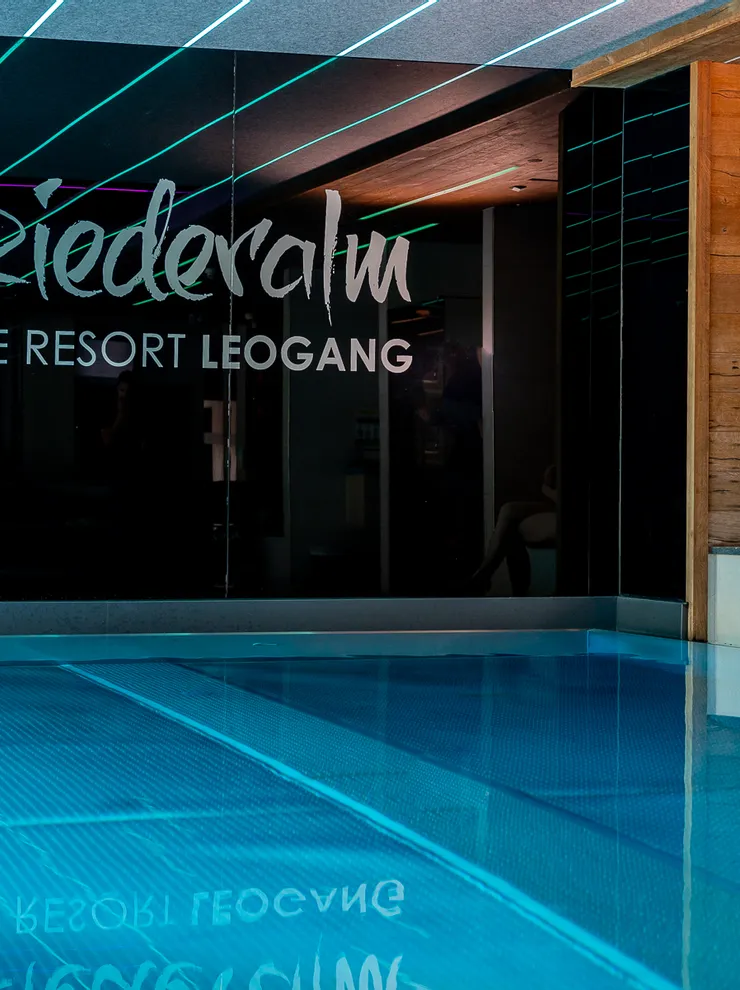 Mother with baby relaxing by indoor pool at Good Life Resort Leogang
