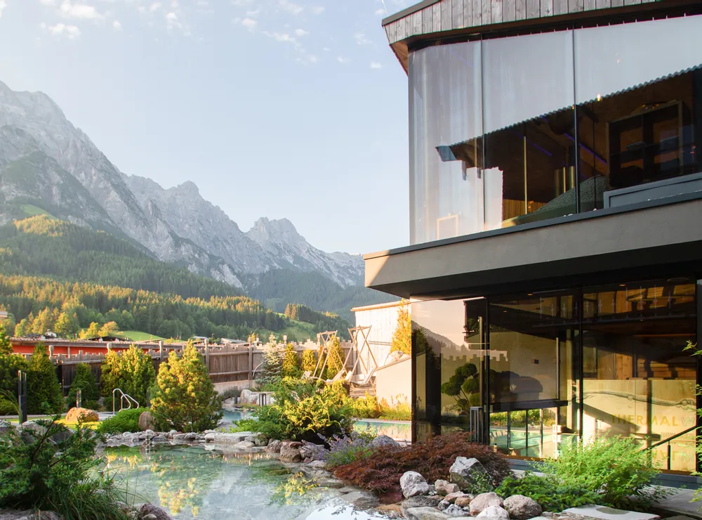 Modern spa resort with kneipp basin and mountain view in alpine landscape