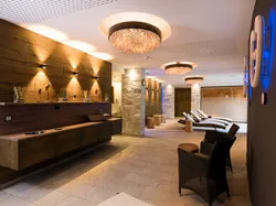 Moderne Wellness-Spa-Lounge mit Korbstühlen, Liegen und stimmungsvoller Beleuchtung