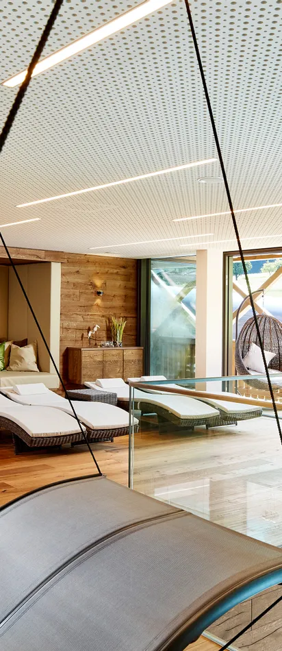 Moderner Spa-Ruheraum mit Liegen, Hängesessel und Panoramafensterblick
