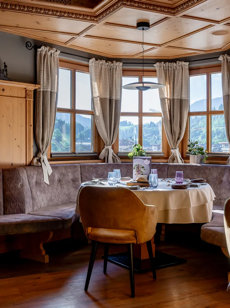 Cozy restaurant corner with wooden interior and panoramic mountain view