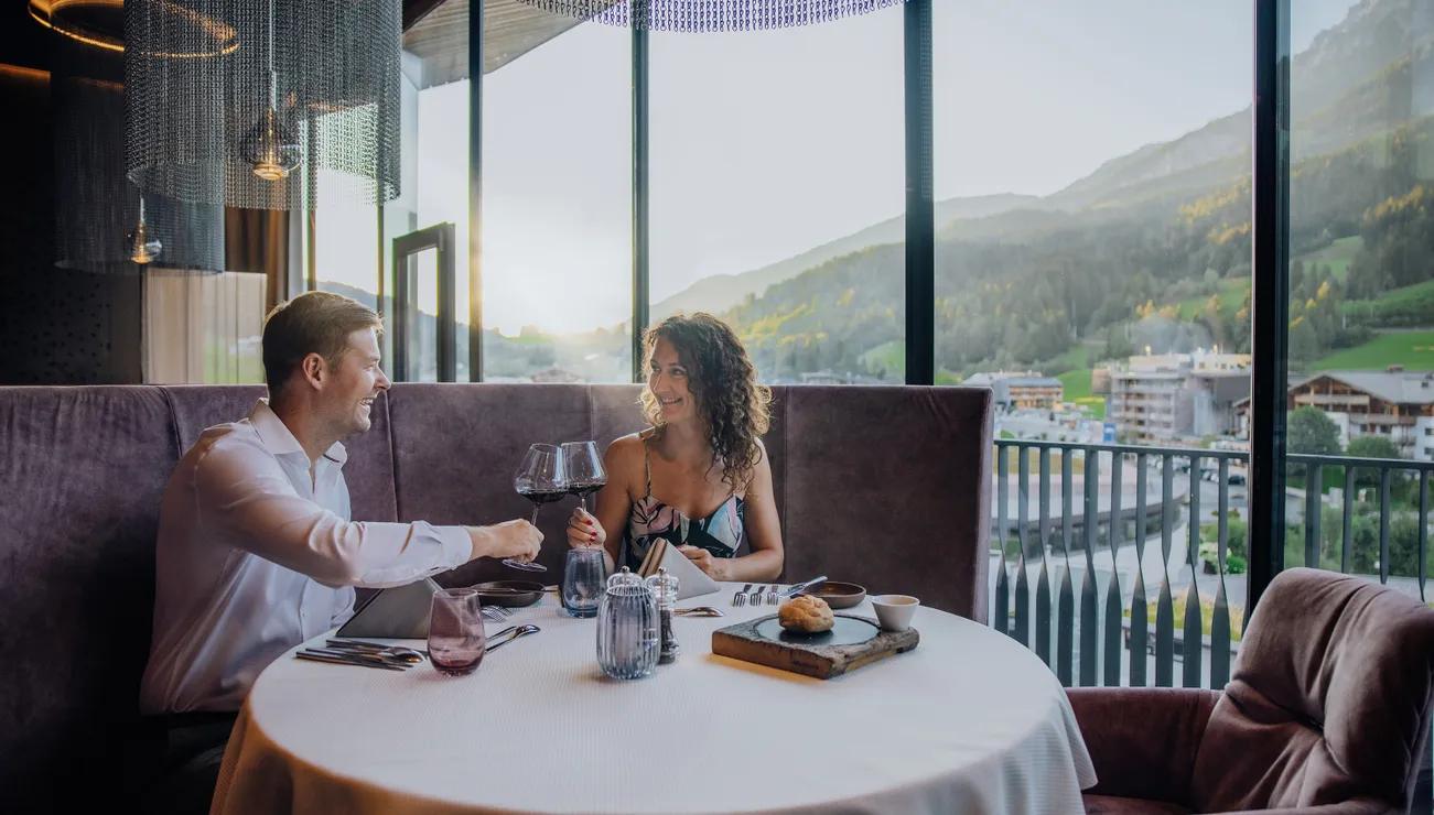 Couple enjoying romantic dinner with wine in a mountain view restaurant