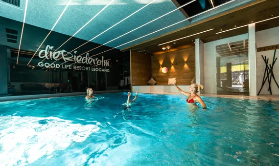 Women playing with a ball in indoor pool at Good Life Resort Leogang