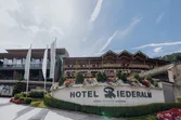 Hotel Riederalm exterior with flower decorations and signage in Leogang resort area