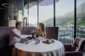 Couple enjoying romantic dinner with wine in a mountain view restaurant