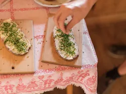 Bread with butter and fresh chives served on wooden board