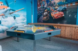 Spielzimmer für Kinder mit Cars- und Planes-Filmtapeten und interaktivem Spieltisch