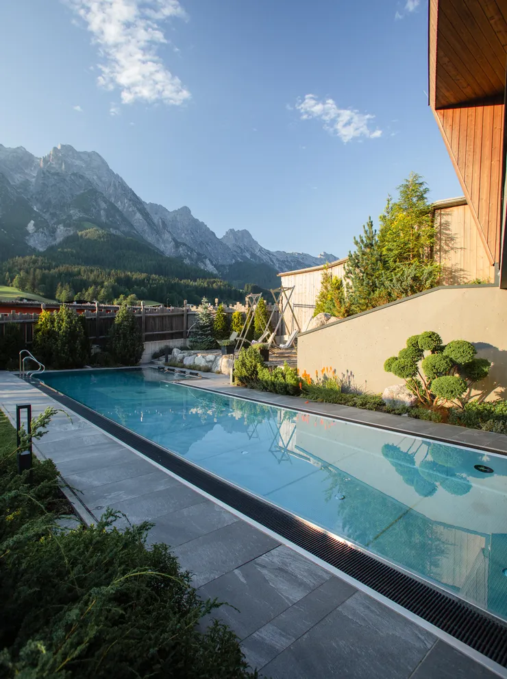 Luxury outdoor pool with mountain view at scenic alpine resort